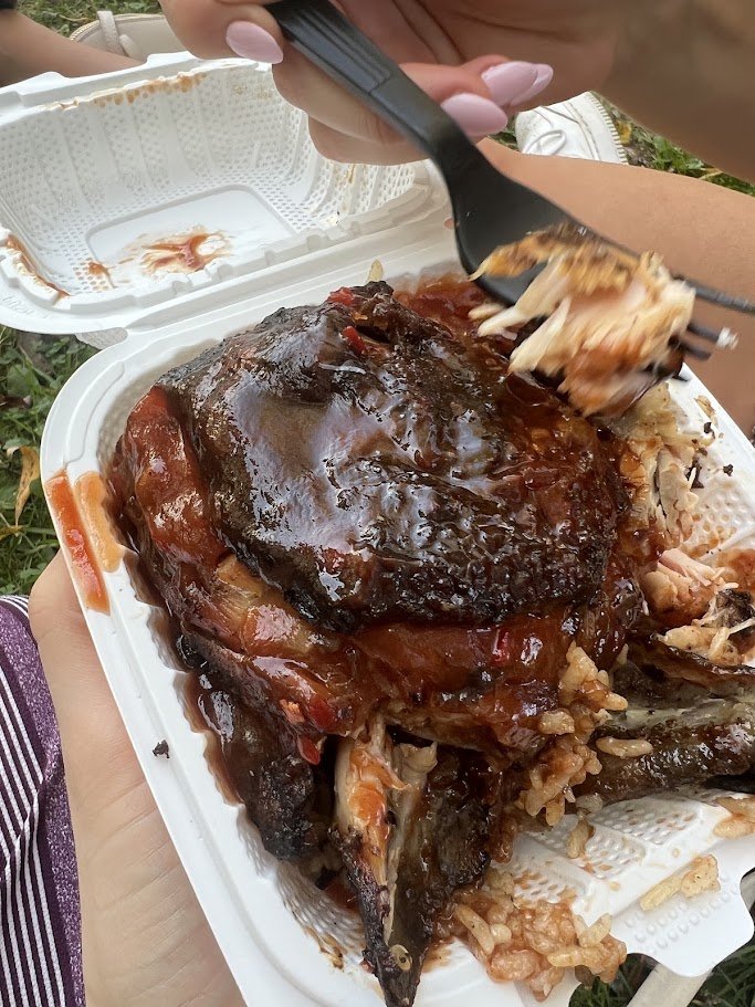 Plates of Jamaican comfort food on a simple table.