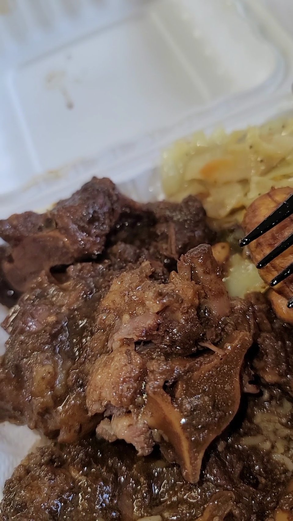 Printed menu with oxtails, chicken, and desserts.